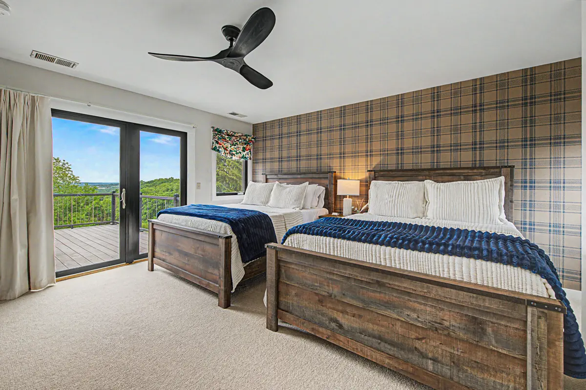 Two-queen bedroom with a door to the balcony