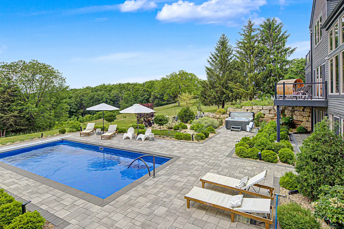 Pool terrace with loungers and valley view