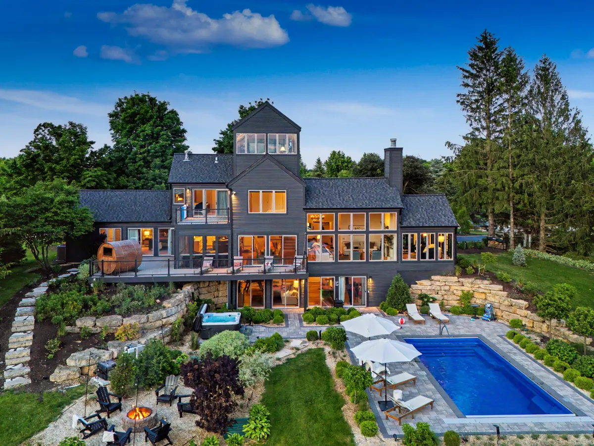 The back of the house and pool terrace on a summer day