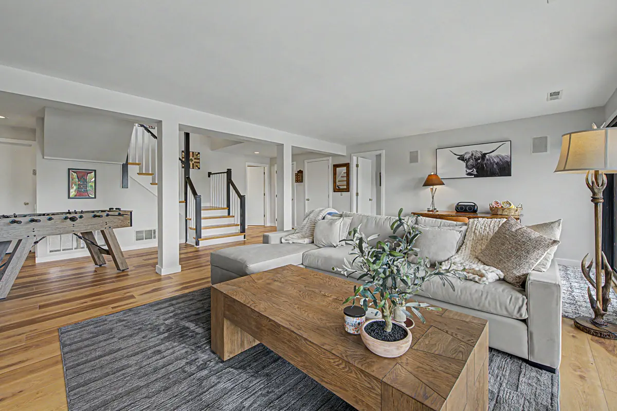 Lower-level family room with sectional and foosball