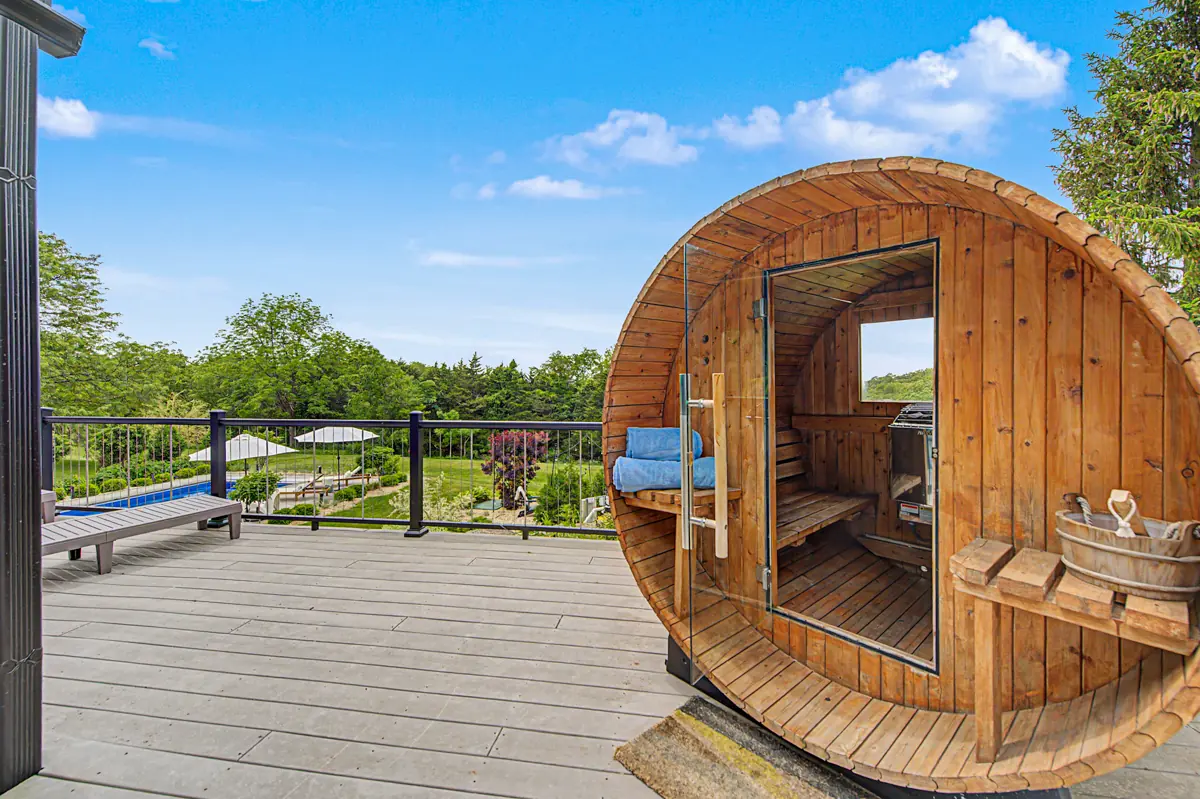 Cedar barrel sauna on the deck above the pool